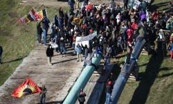 Protesters gather on pipe
